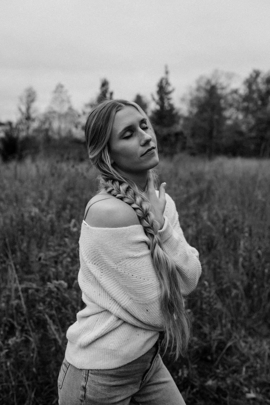 black and white image woman posing in field