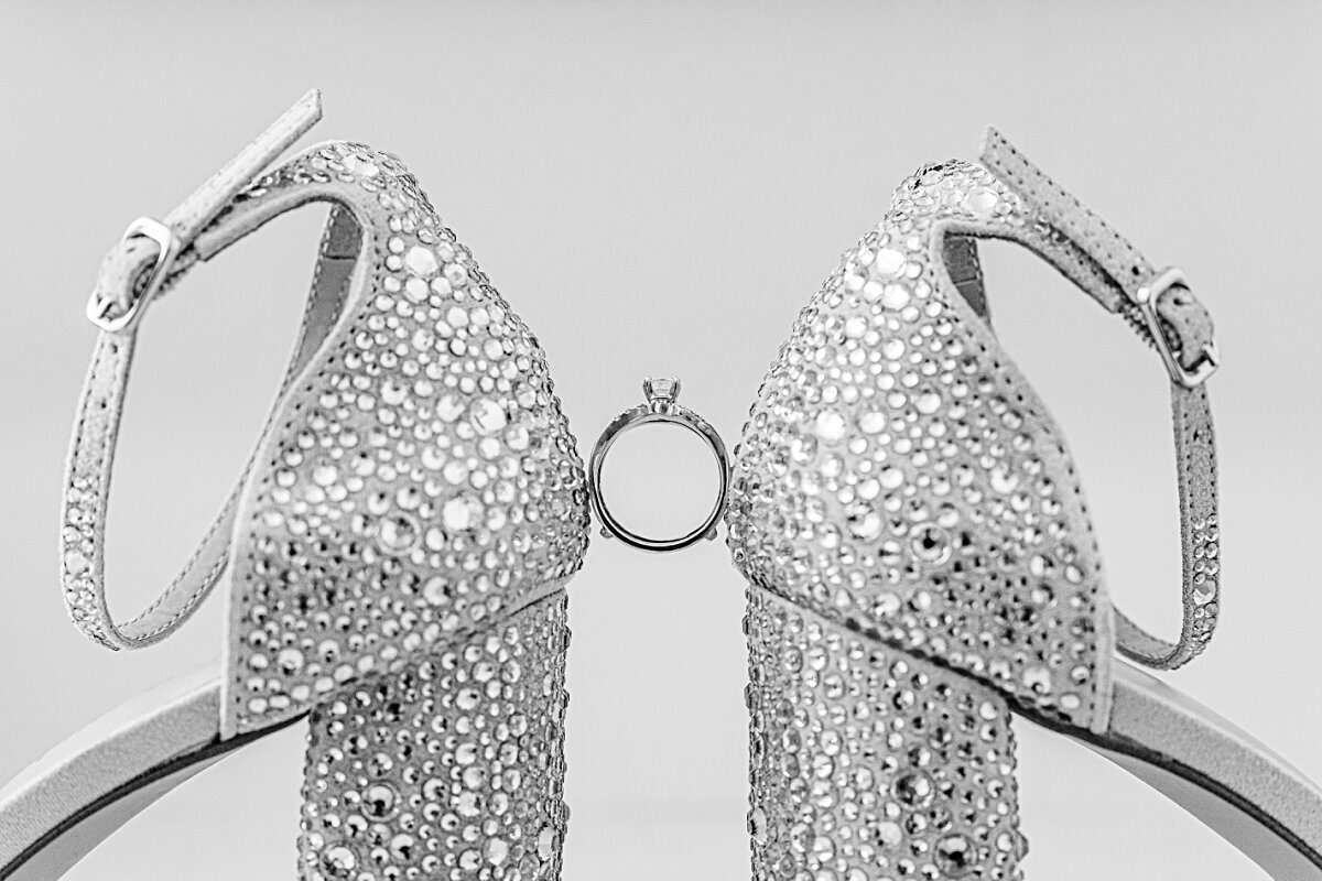 engagement-wedding-ring-between-brides-shoes