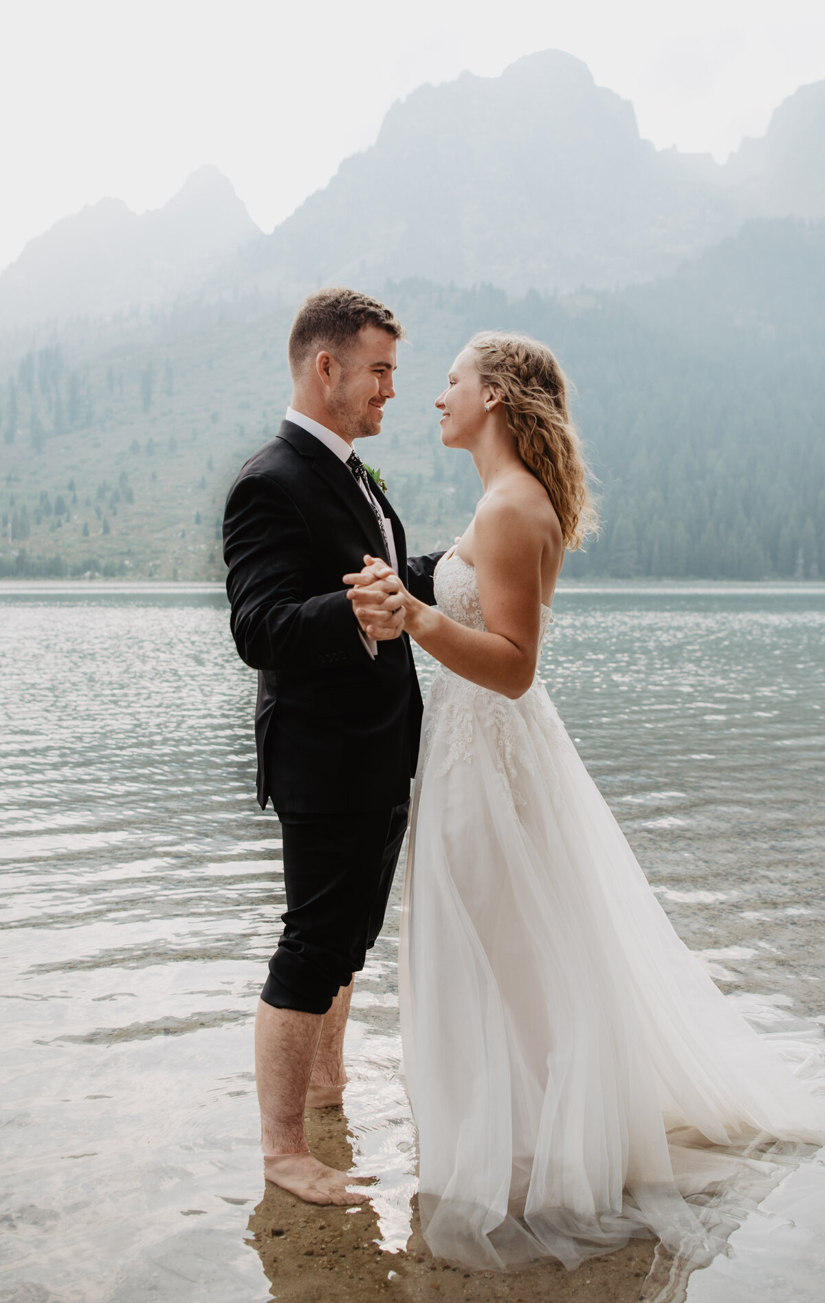 Jackson Hole Photographers capture couple dancing in water after Grand Teton wedding