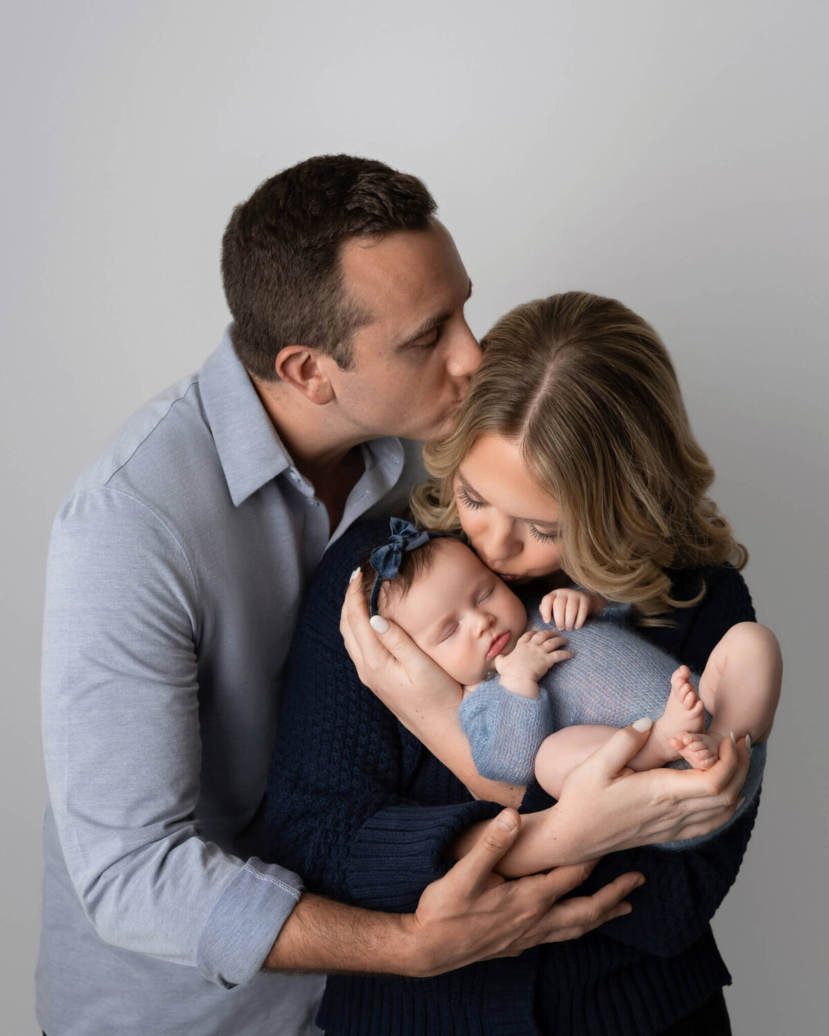 family photo during newborn session with different shades of blue