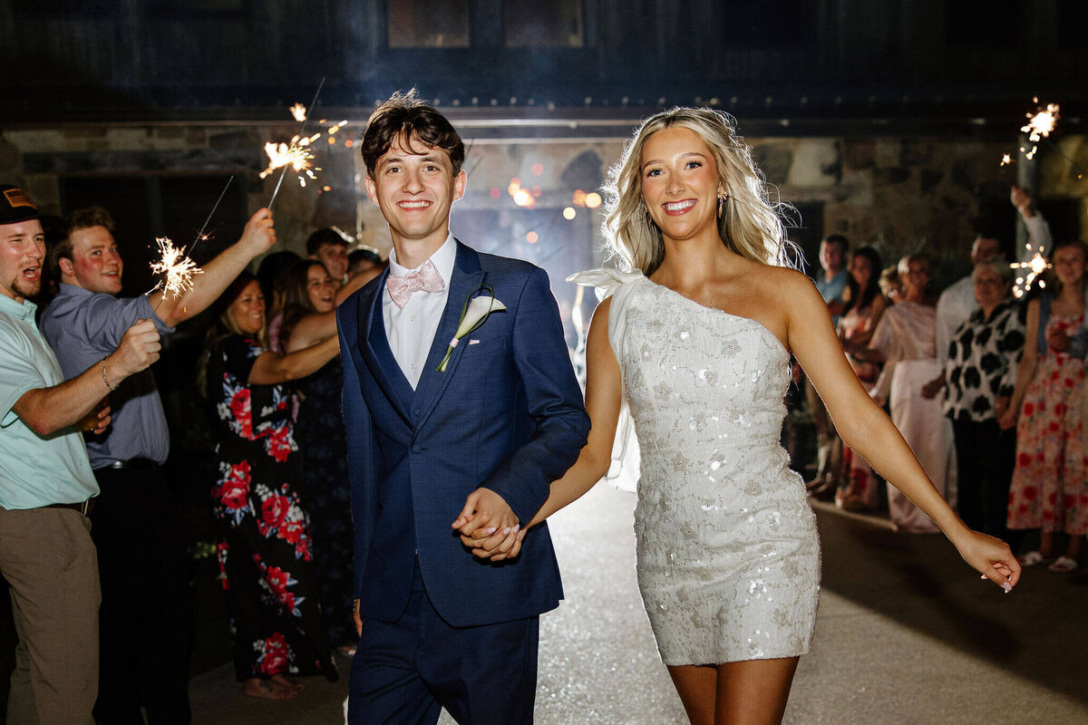 bride and groom running through sparkler exit
