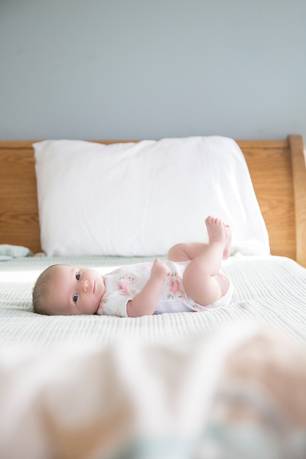 baby girl laying on a bed