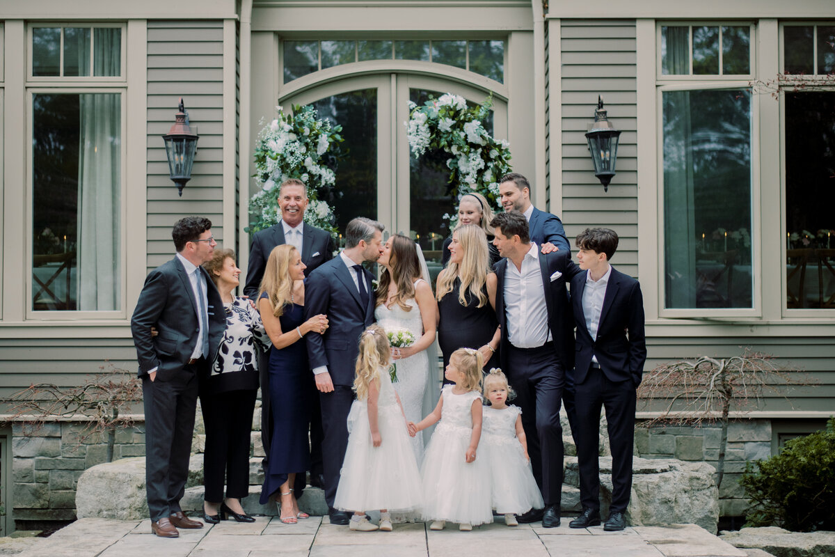Bride's family during a portrait session after a ceremony. They share a laughing moment.