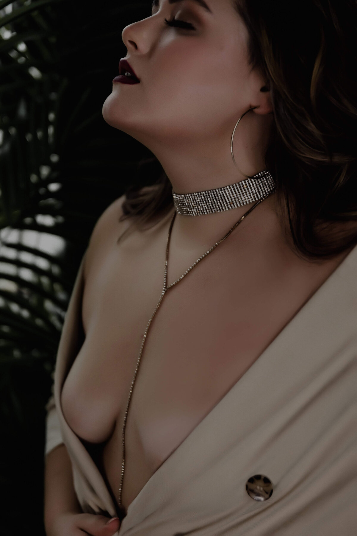 woman standing in body jewelry posing for boudoir