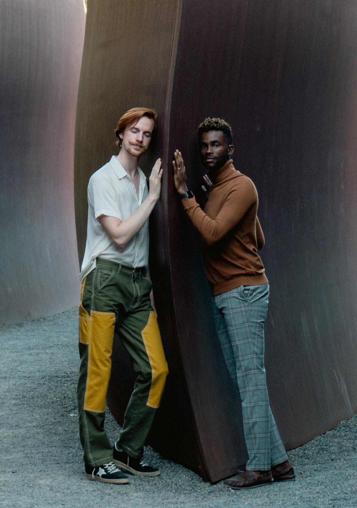 Queer gay engaged couple at Olympic Park Sculpture Park in Seattle during golden hour with neutral tones