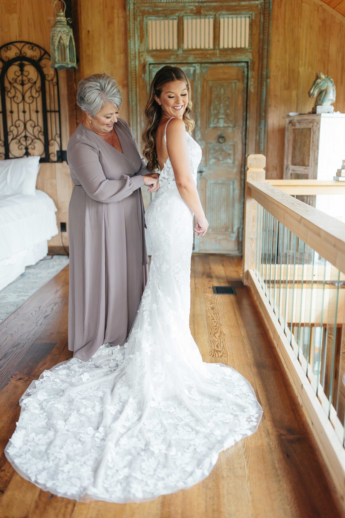 Mother helping bride dress with crooked river wedding photographer