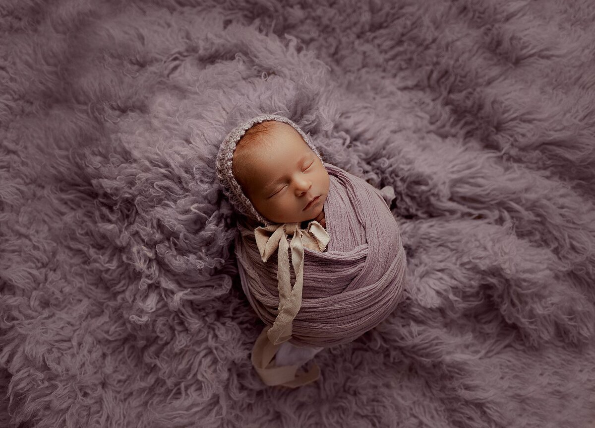 Timeless newborn portrait of baby girl in white wrap, captured by Austin newborn photographer