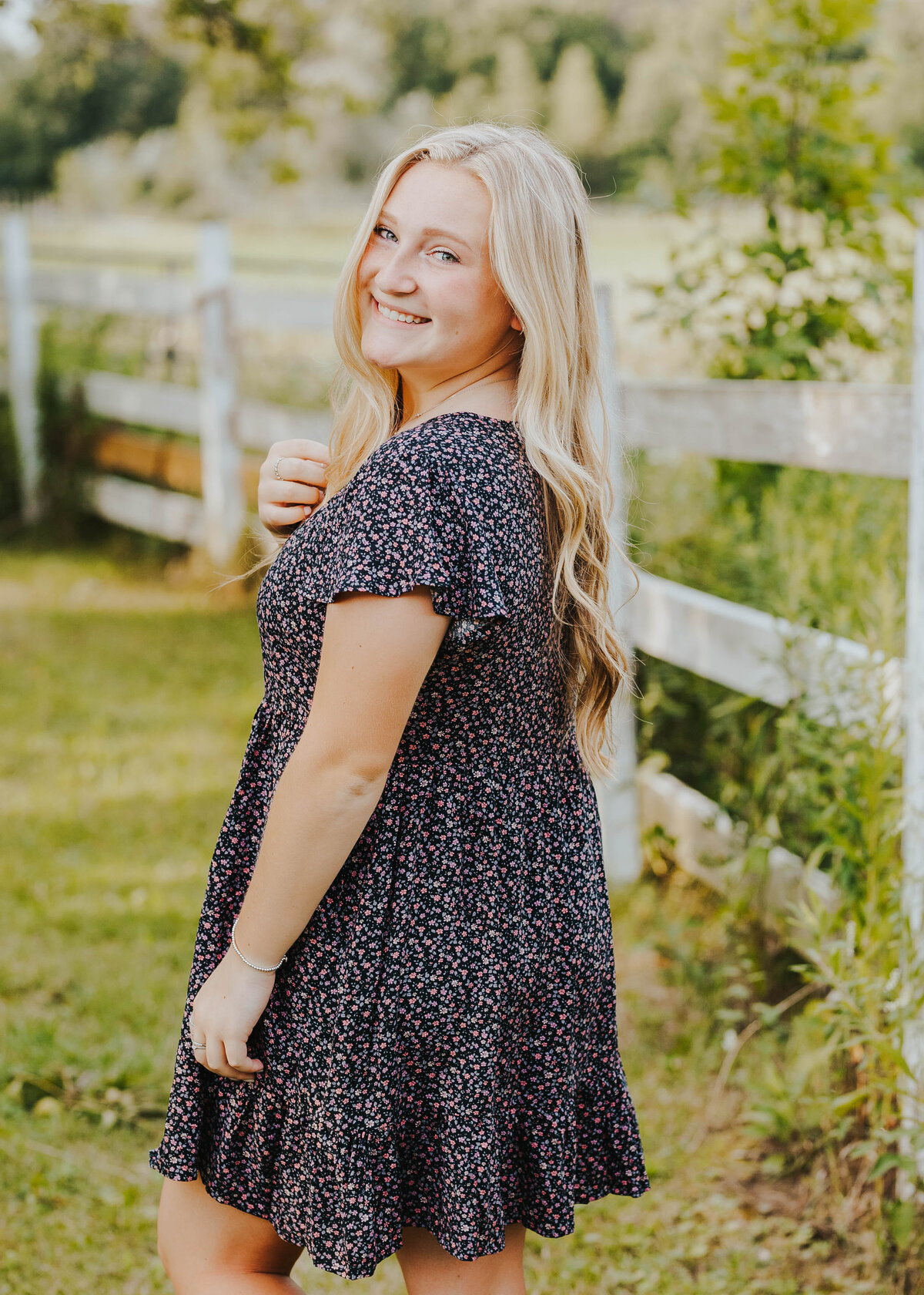 woman posing by fence