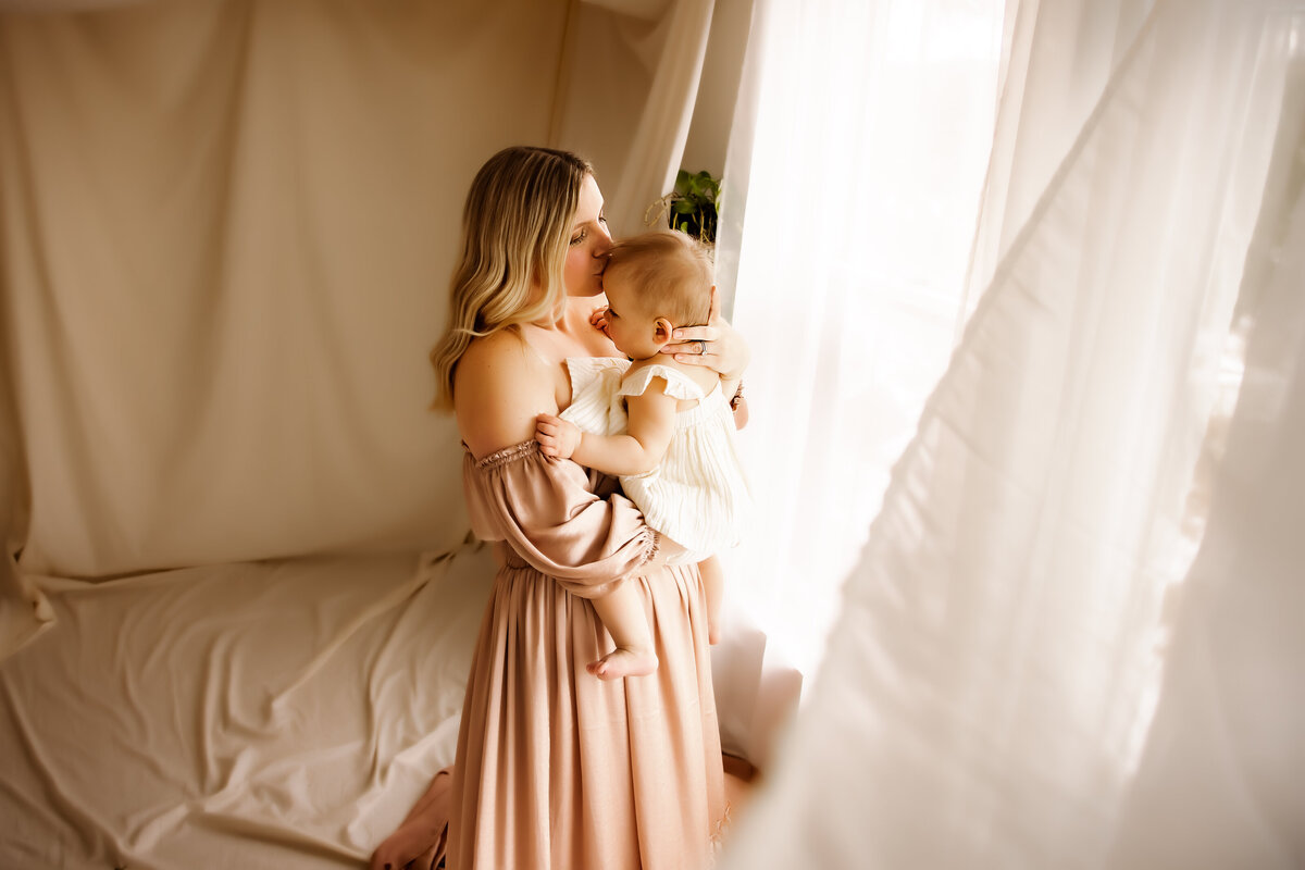 Intimate motherhood photo of mom and baby in studio Syracuse NY