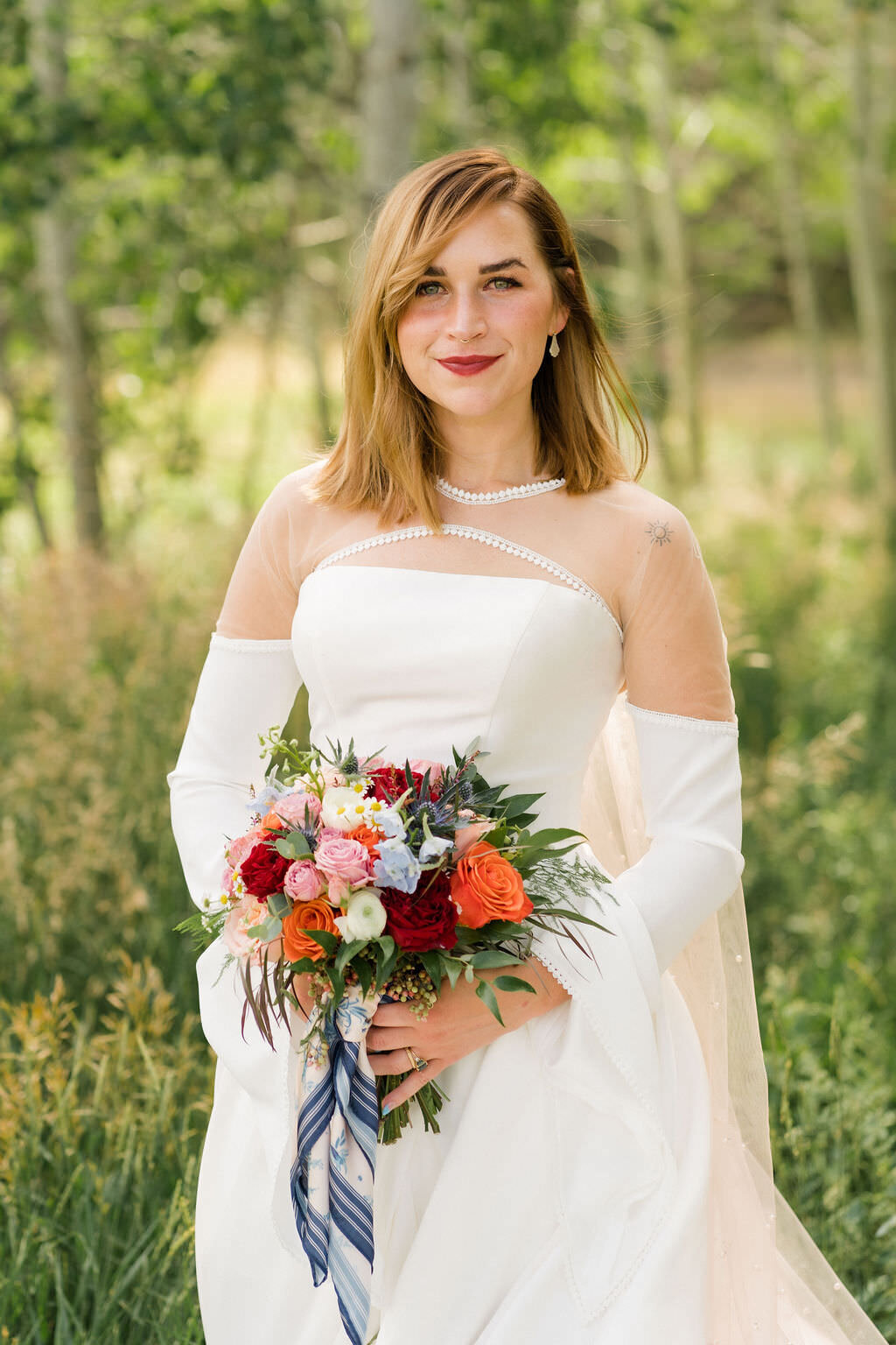 bride smiling and holding her bouquet with both hands