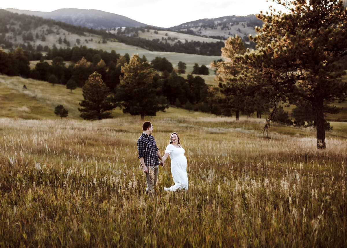 Breathtaking couples pregnancy portrait in a field in the Colorado Mountains