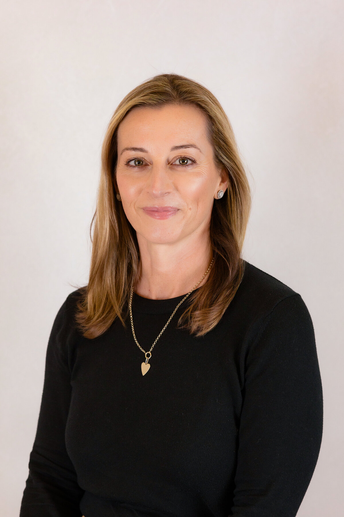 Woman wearing black and sitting for a professional headshot in the Bay Area