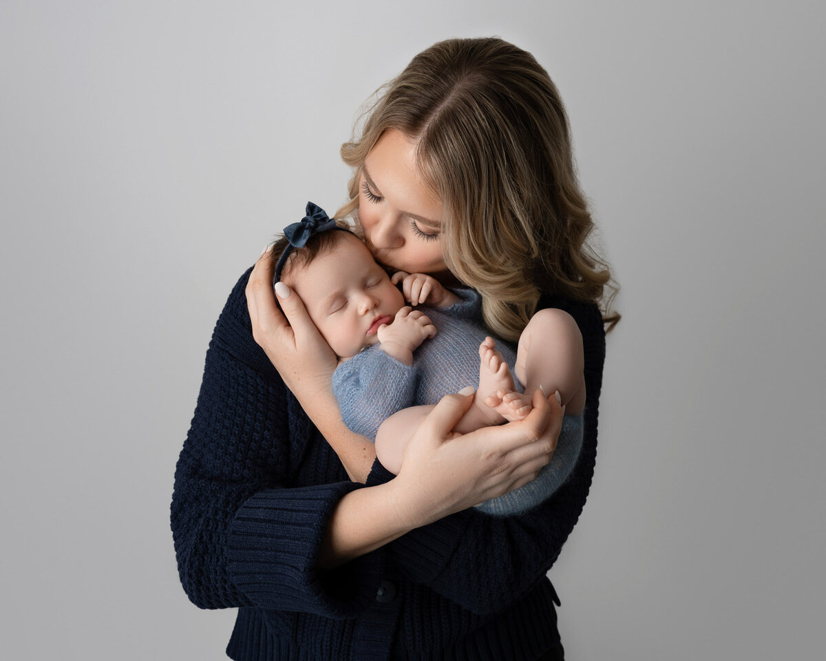 Mother holding newborn baby intimate portrait Austin professional family photographer
