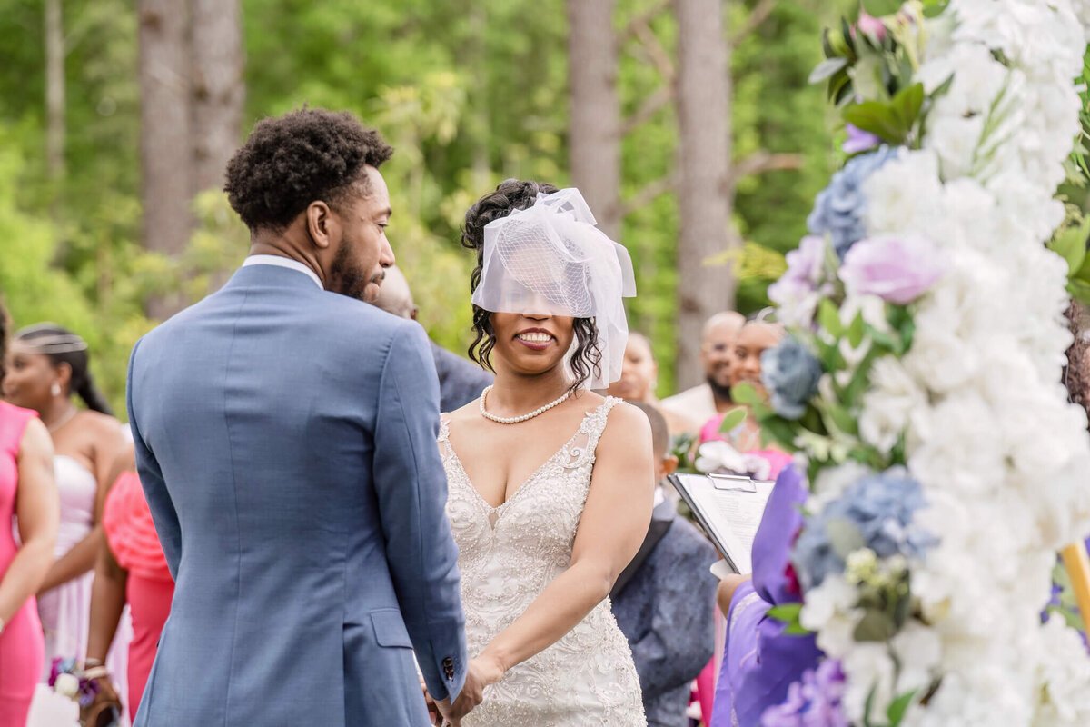Emotional moment as the father of the bride walks her down the aisle at a beautiful outdoor wedding.