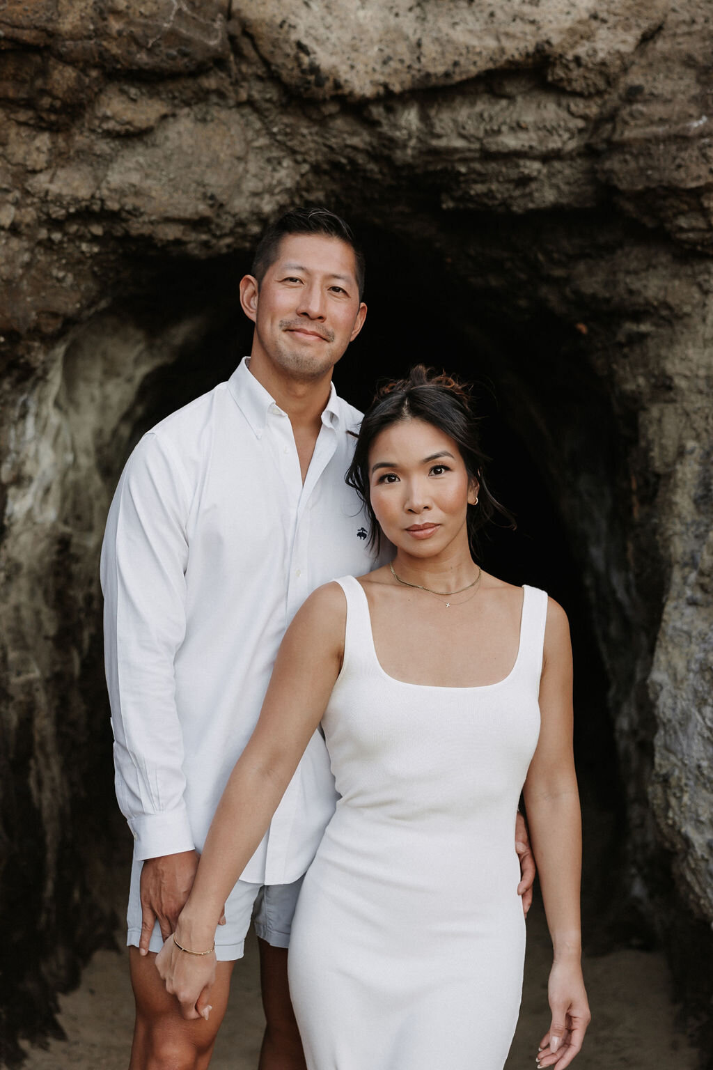 Romantic couples pose at Holana Blowhole in Honolulu by hawaii wedding photographer