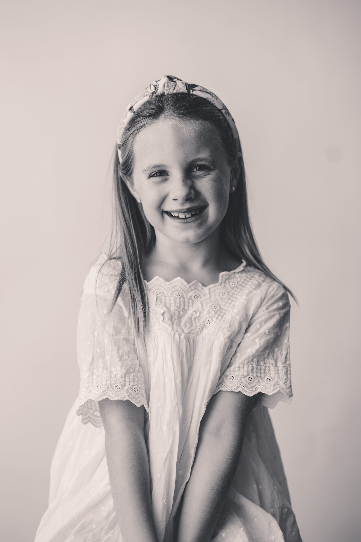 Young girl smiles at the camera during Personality Portrait Session in Charleston, SC.
