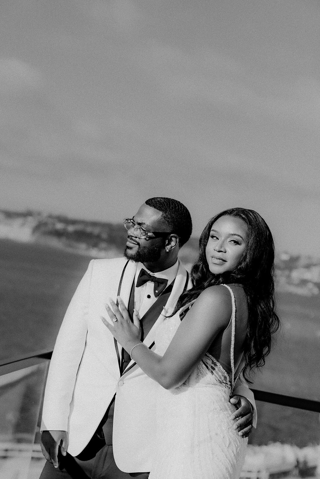 Bride and groom smiling in San Diego with ocean in the back