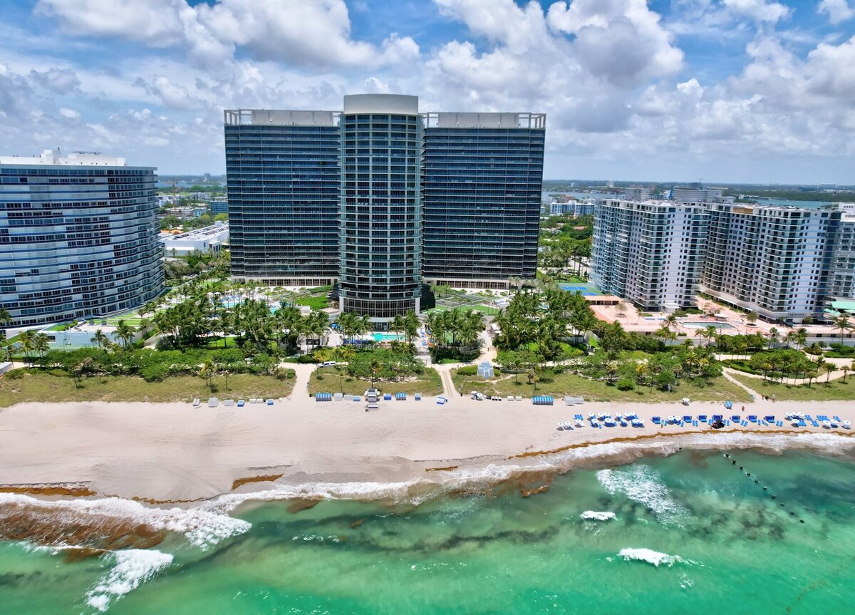 Aerial view of St. Regis Bal Harbour Center Tower with pools and beachfront, home to PH-888 penthouse