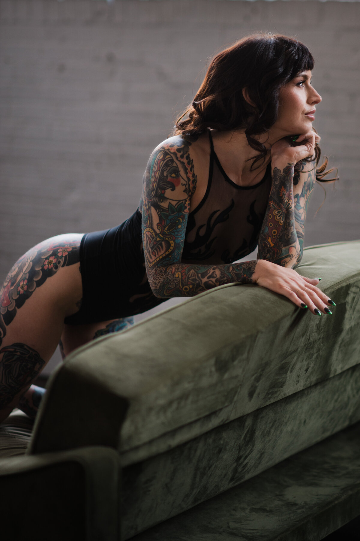 Luxury boudoir photoshoot highlighting artistic tattoo boudoir and confident posing.