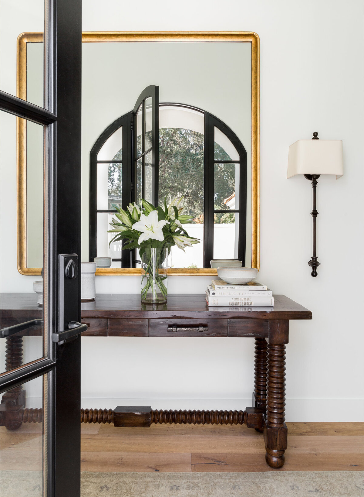 elegant-entryway-arched-window-gold-framed-mirror