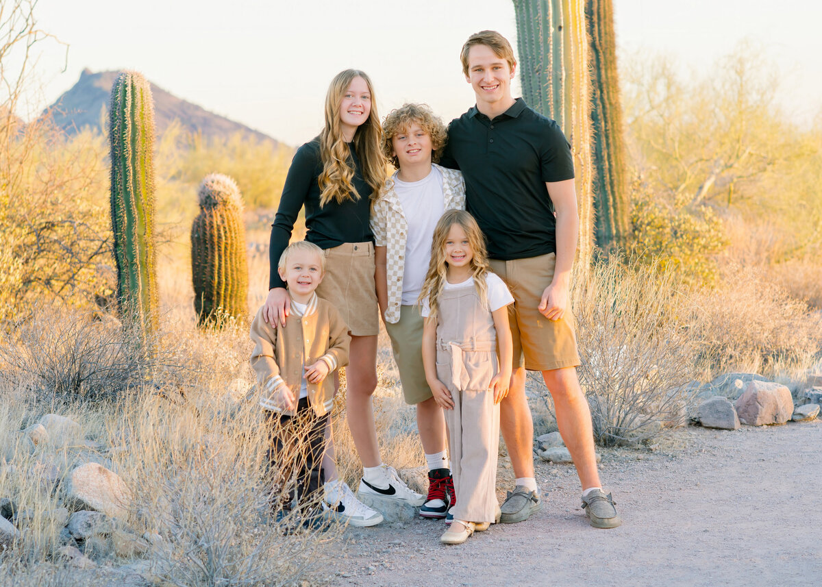 siblings posing together for a family photo shoot in the north scottsdale desert