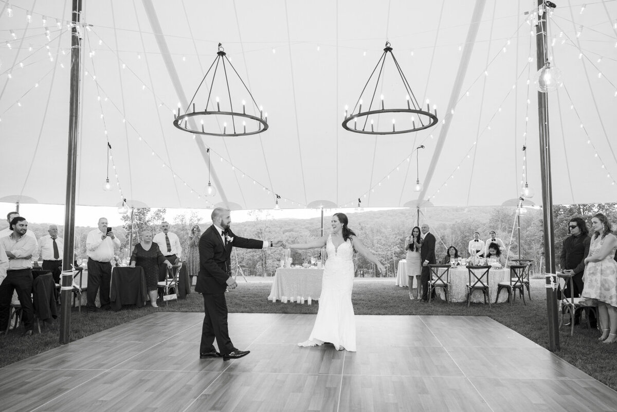 bride and groom share their first dance in reception tent - candlelight farms inn wedding