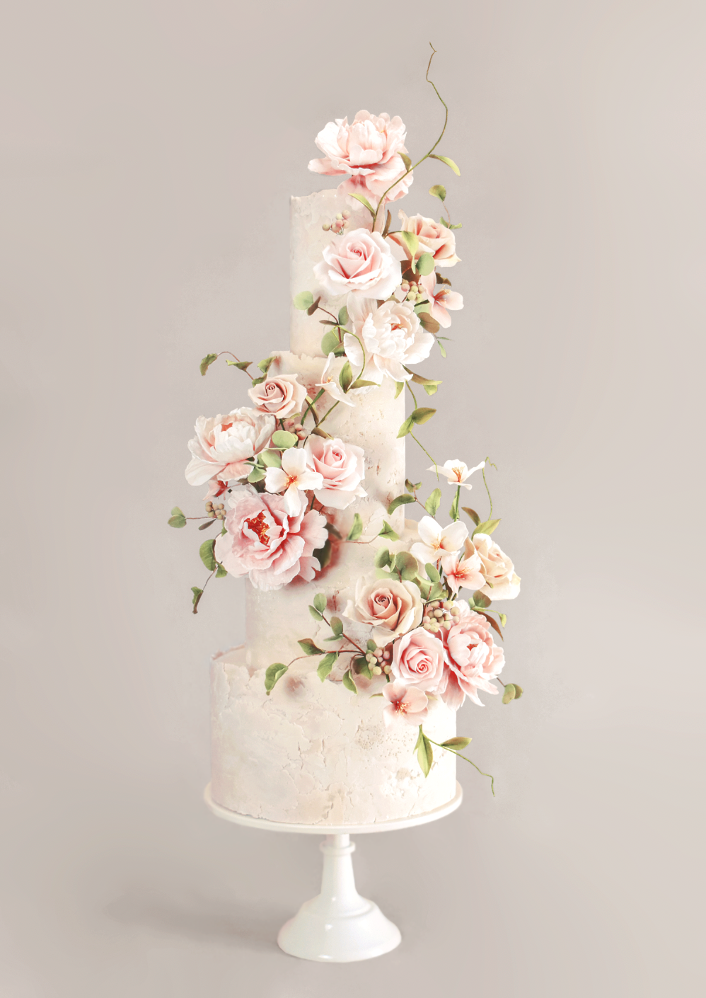 four tiered wedding cake with wild and whimsical pink sugar flowers