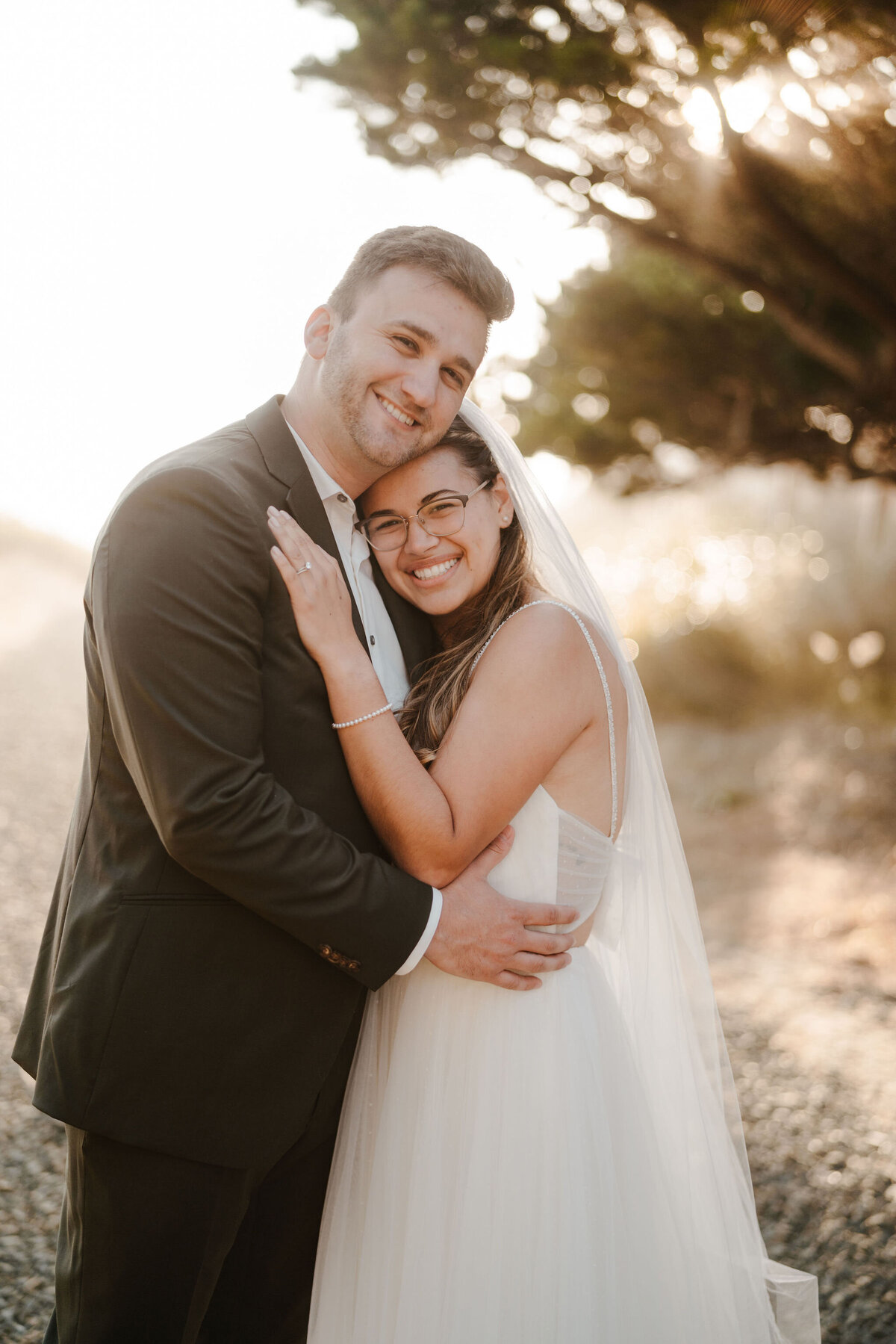a bride hugging her husband