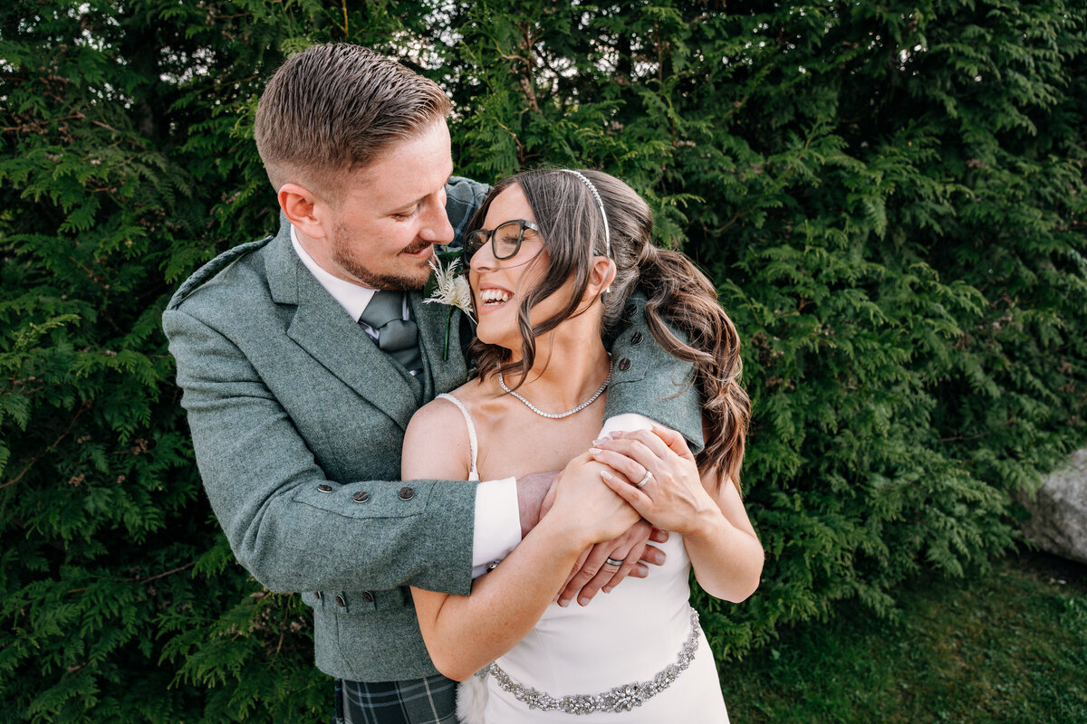 Couple cuddling at Radstone Hotel in wedding day 