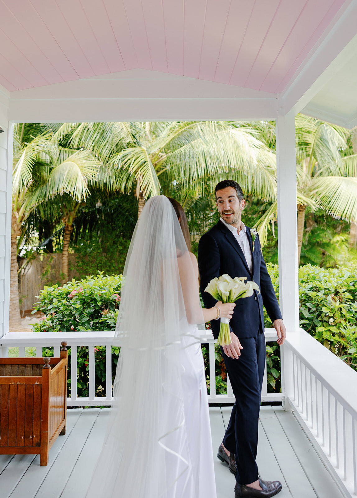 Minette and Evan share an intimate first look on the porch of Casitas at Cheeca. Islamorada wedding photography by Claudia Amalia.
