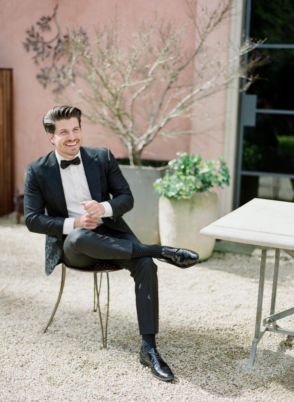 smiling groom relaxing in tux