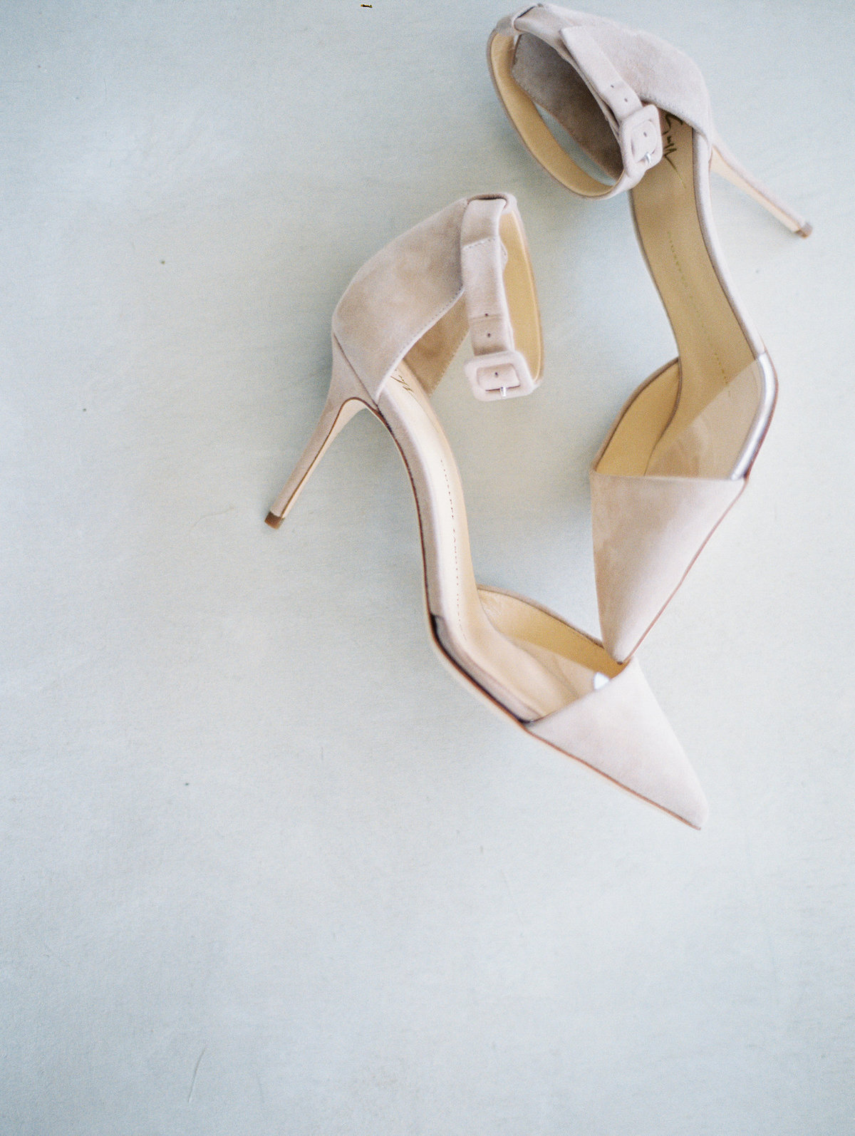 close up of pink suede pointed toe heels with translucent panel