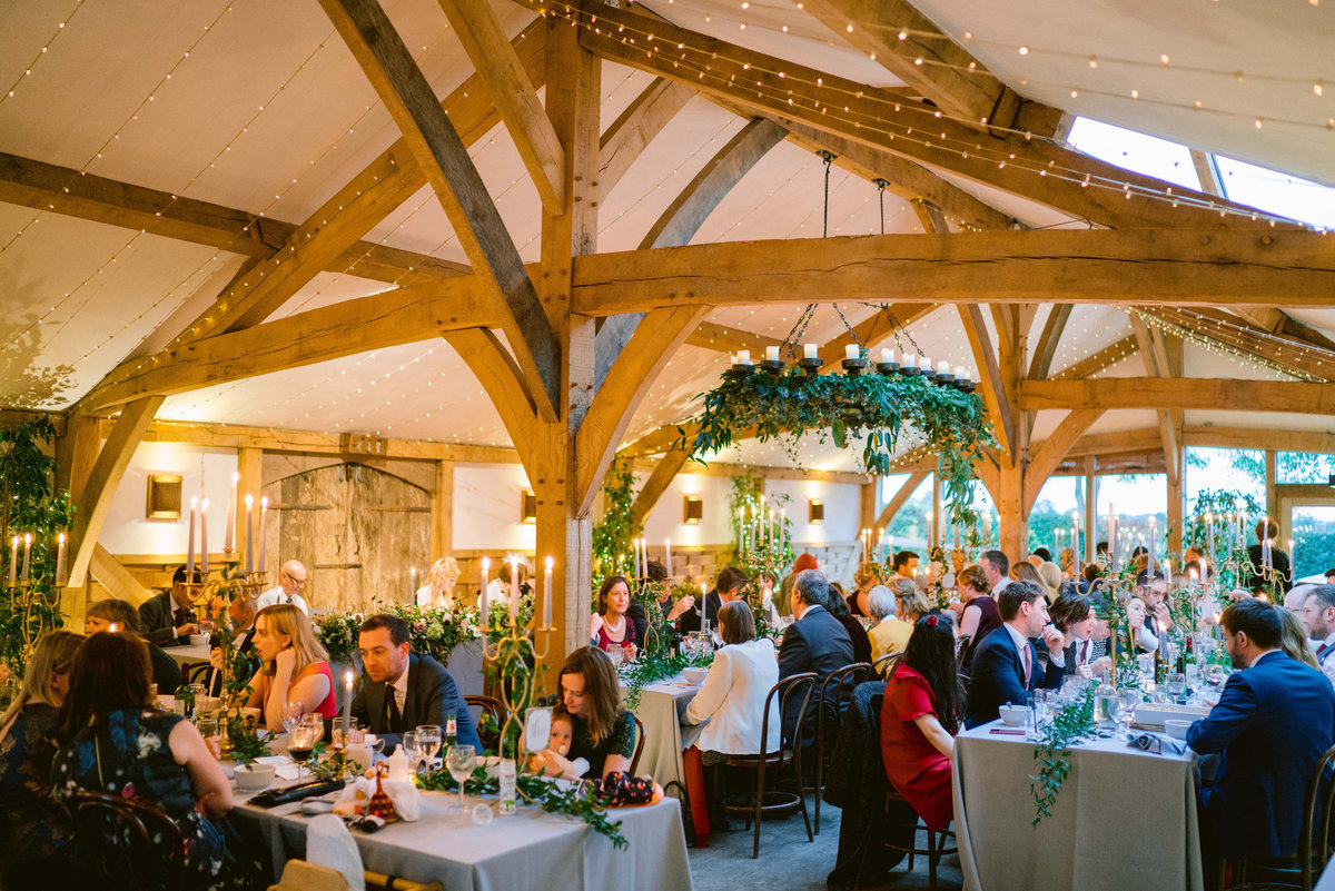 guests enjoying the wedding breakfast in the barn