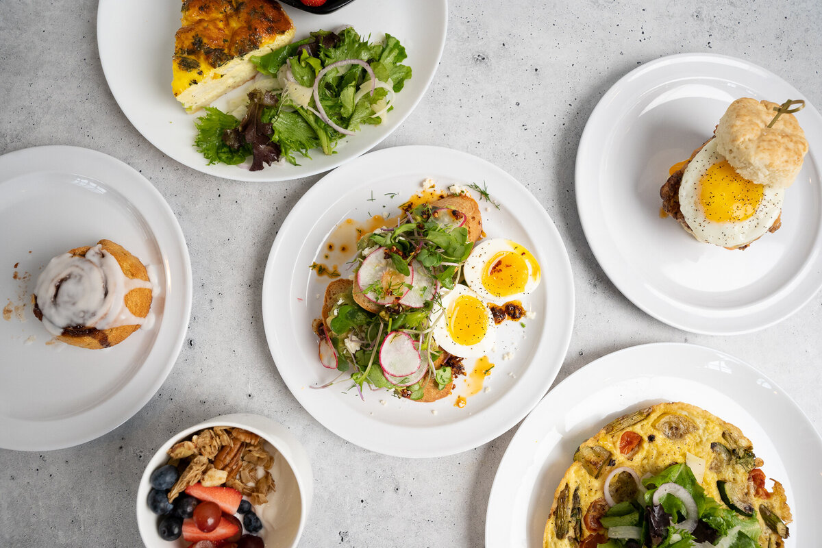 A variety of breakfast foods in bowls and on plates at Mason Dixon Bakery & Bistro