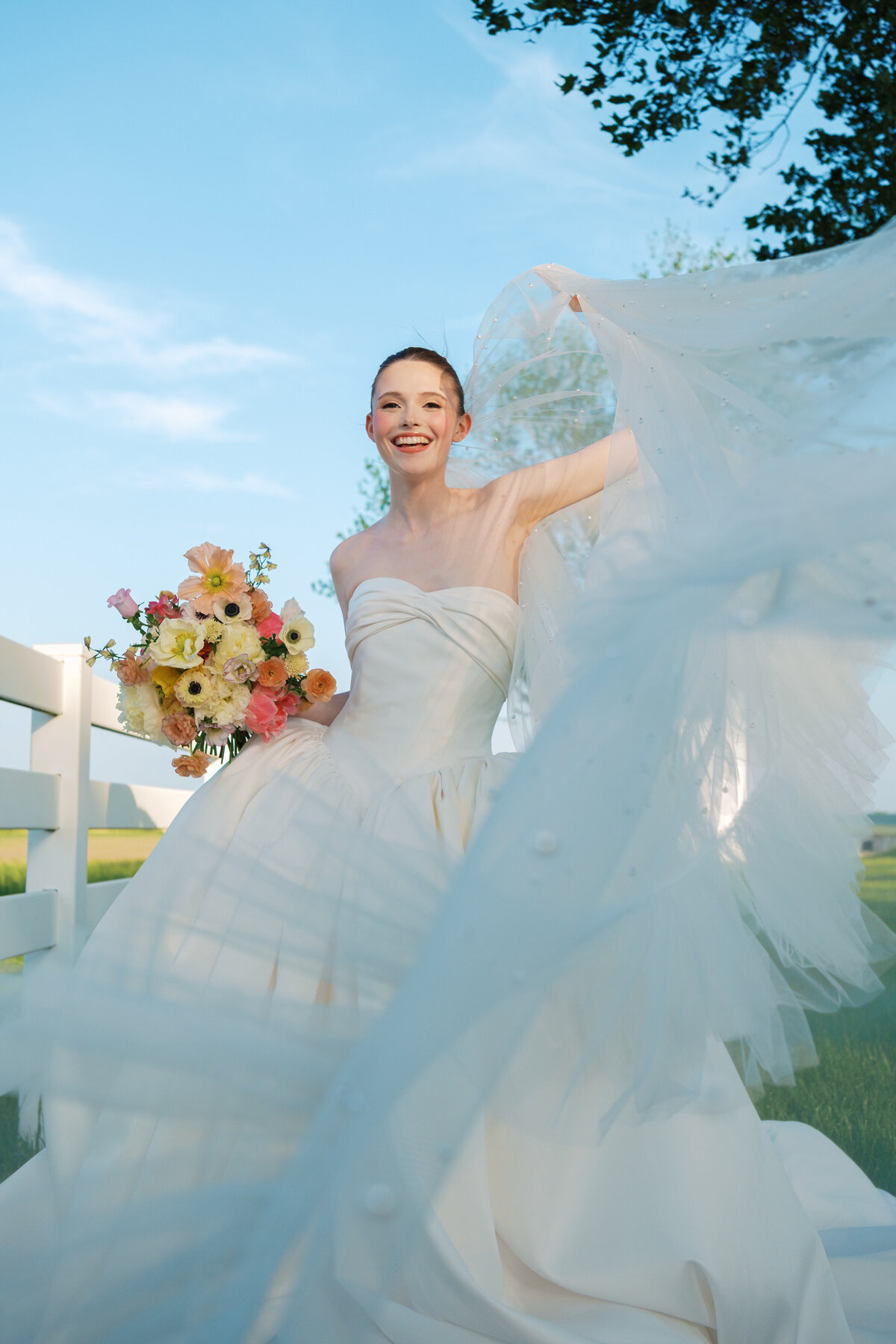 bridal portrait with colorful bouquet, Mimi's Couture gown, and large veil at Lone Summit Ranch