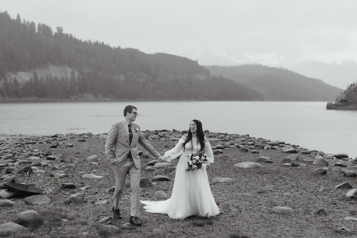 Black and white photo of Cerise and Geoff happily walking at the lakeside