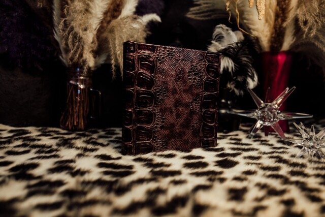 Boudoir photography keepsake album on leopard rug in Lubbock, Texas photographer in Amarillo TX