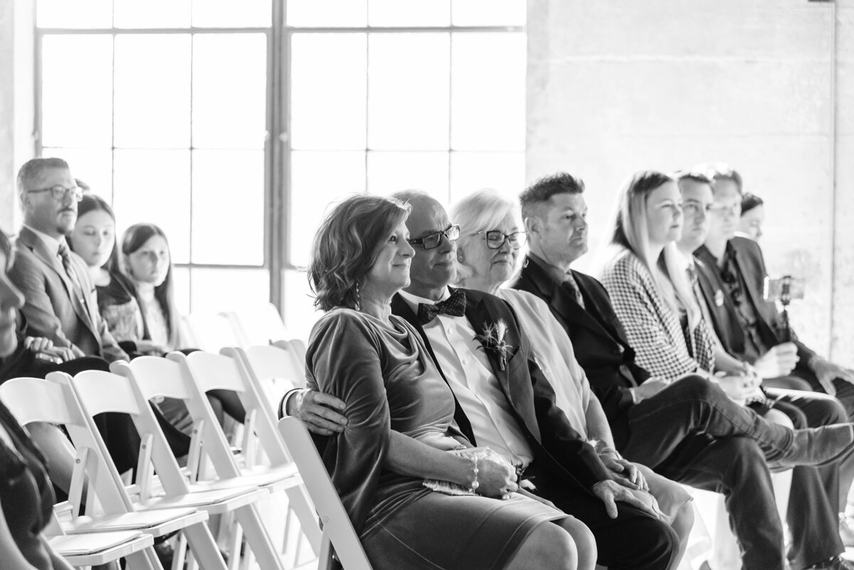 Bride's mother and father smiling as they watch the ceremony at Olde Dobbin Station