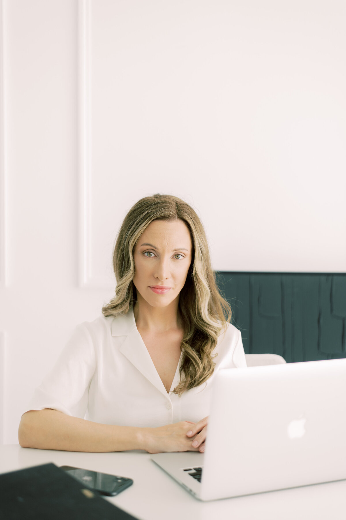 Headshot of woman at desk and laptop