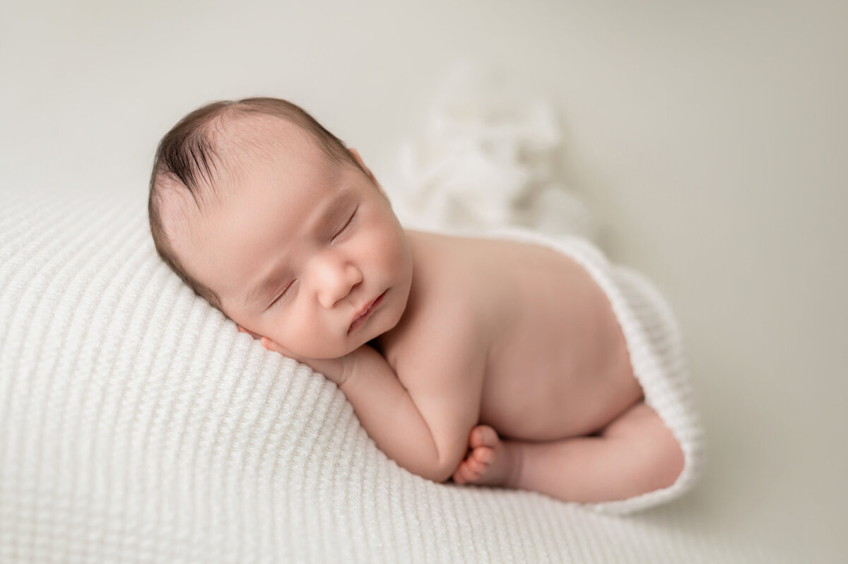 Close-up of sleeping baby in creamy tones – Houston newborn session.