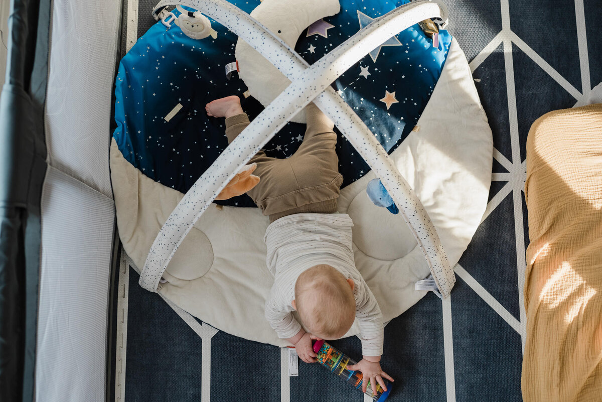 Baby having tummy time on living room floor.