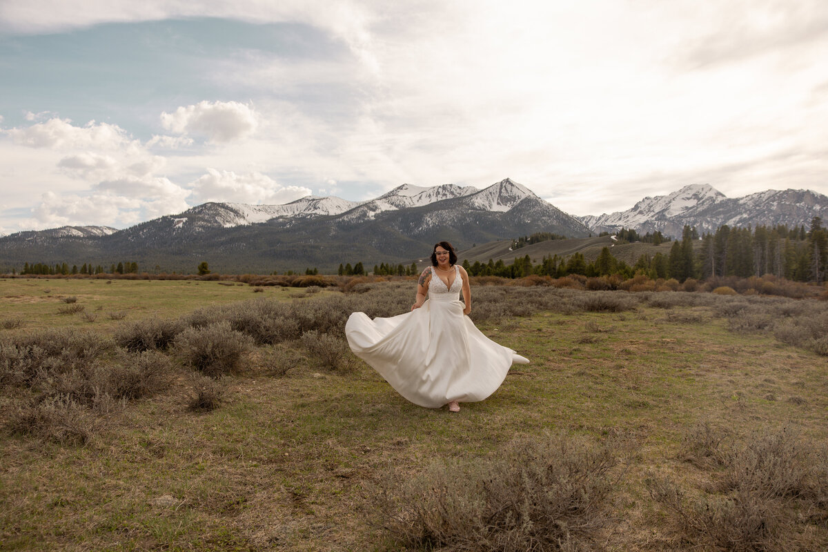 Bride running in the mountains taken by Idaho elopement photographer.