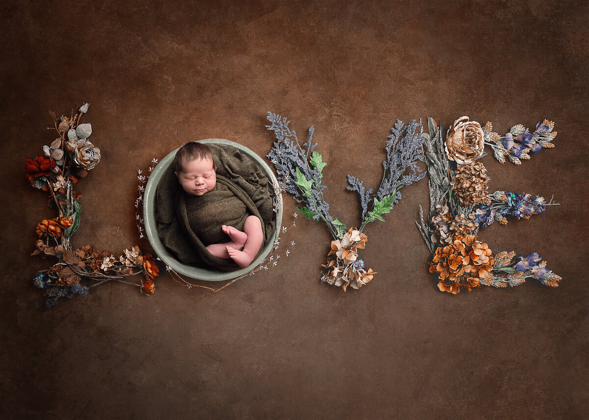 Boy newborn in digital LOVE background in akron ohio studio.