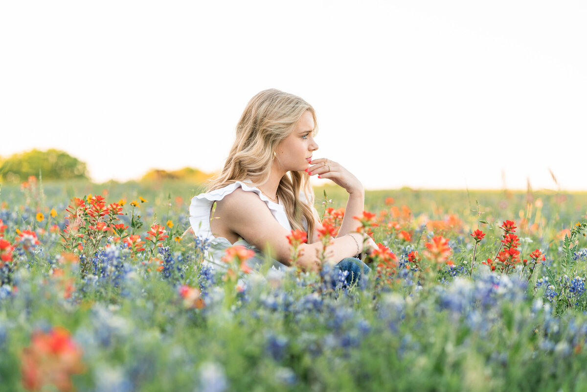 High school girl with casual outfit in the wildflowers for senior photos. In Austin Texas.