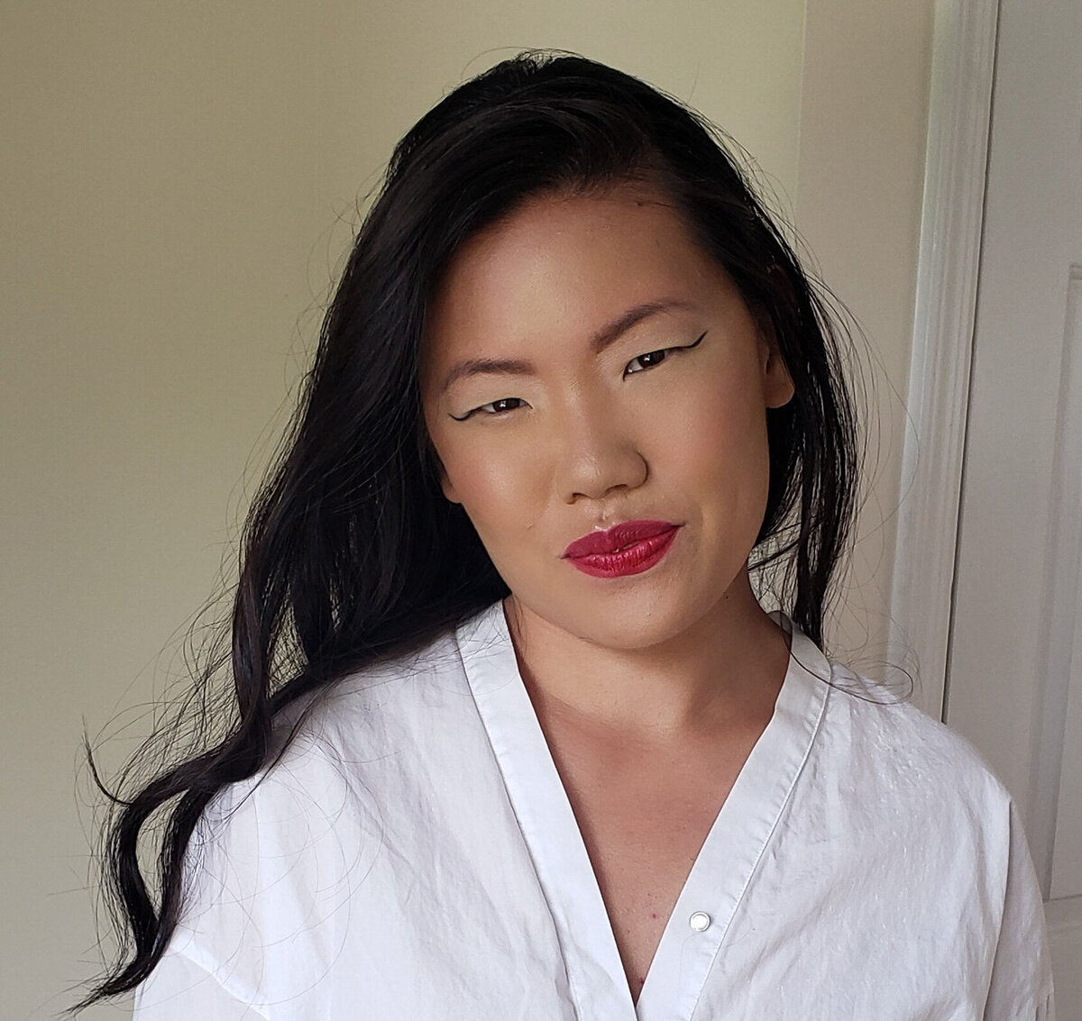 Modern bridal look featuring winged liner and a bold lip – styled by NYC makeup artist Lydia Arroyo.