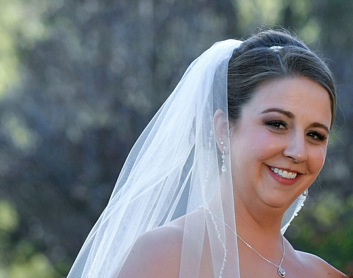 Brunette bride with classic bridal makeup with purple eye makeup lots of lashes