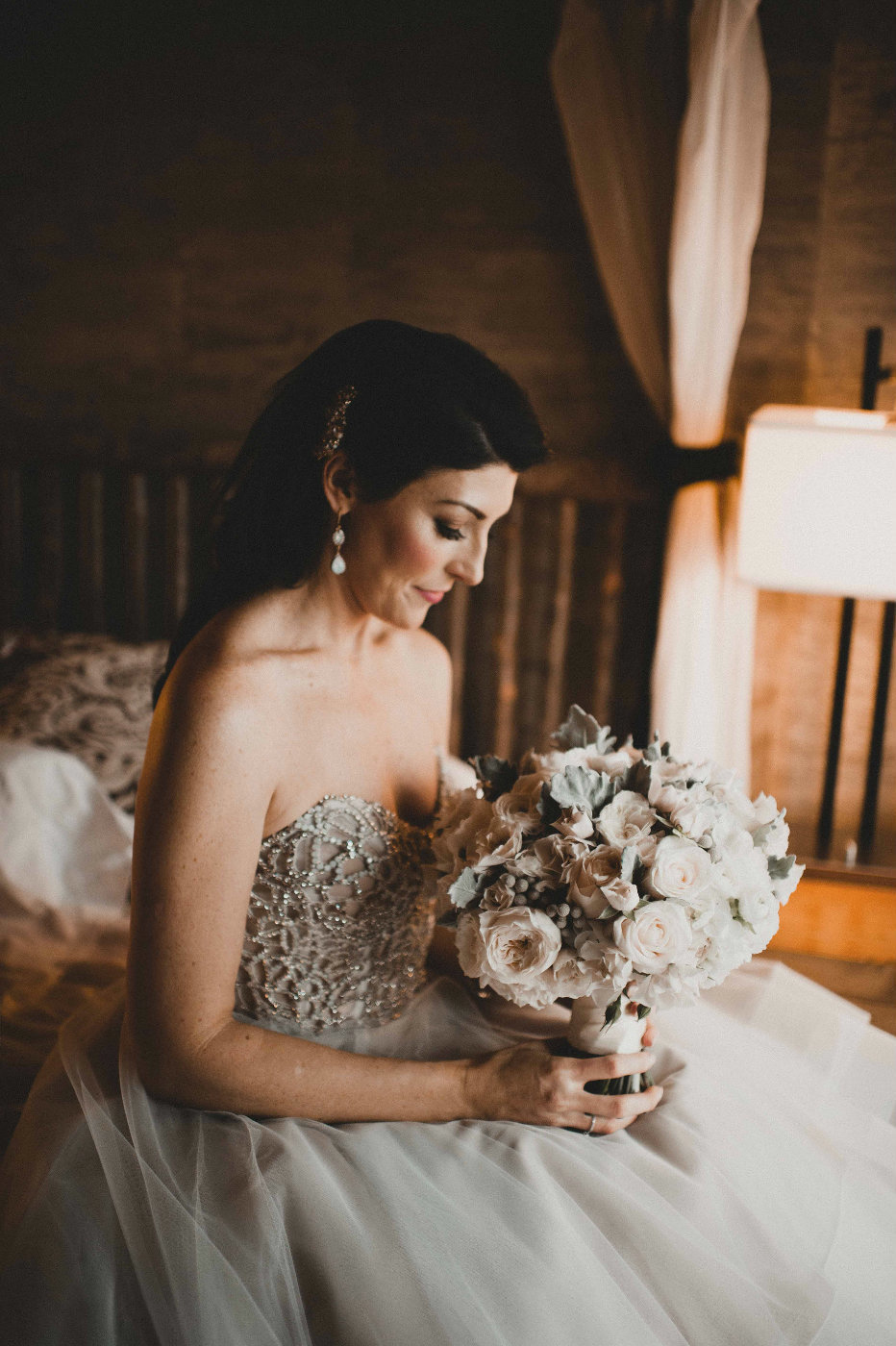 Lovely off white wedding dress complements the white and silver bridal bouquet perfectly.
