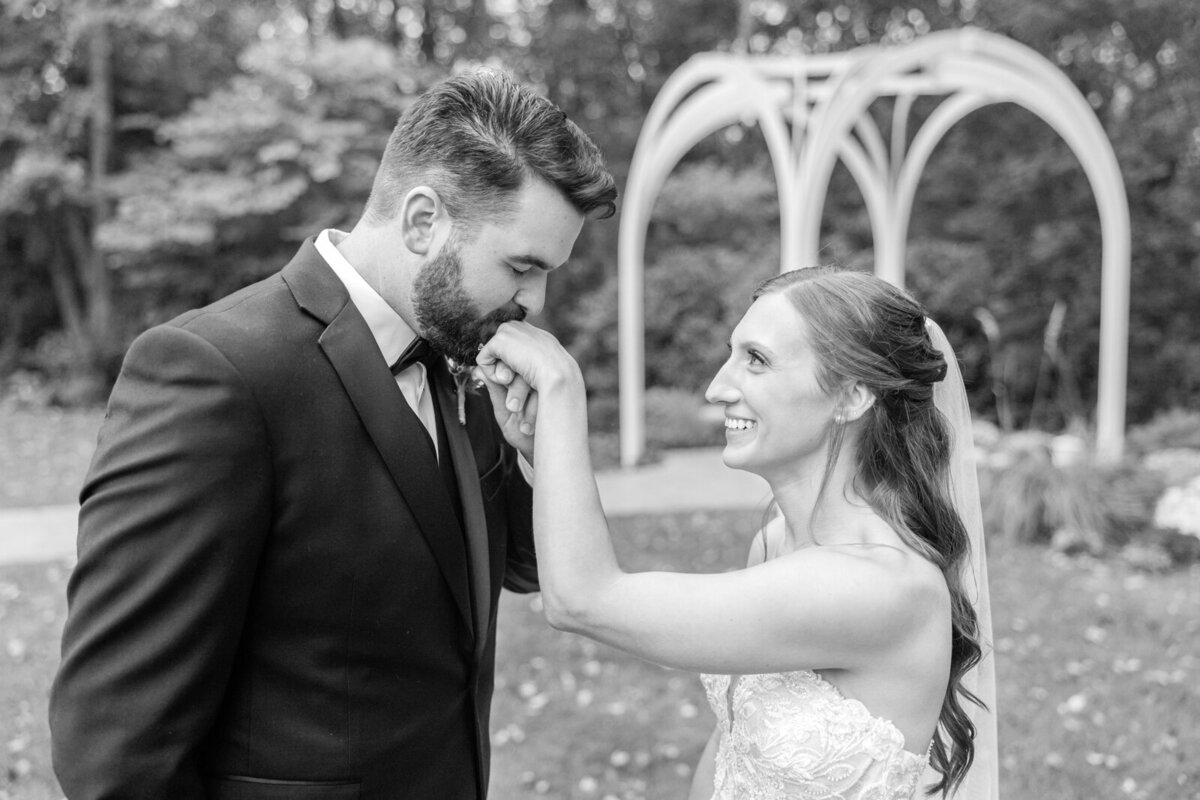 A groom kisses the hand of his new wife