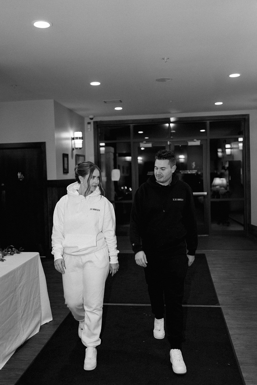 Bride and groom entering Boatwerks wedding reception in Holland Michigan celebrating with guests.