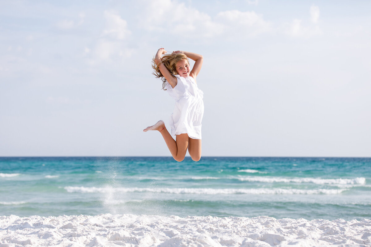 girl jumping in front of gulf, 30a